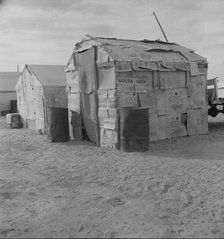 Migratory field worker's home on the edge of a pea field, Imperial Valley, California, 1937. Creator: Dorothea Lange.
