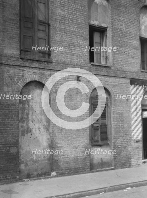 Facade of a multi-story building, New Orleans or Charleston, South Carolina, between 1920 and 1926. Creator: Arnold Genthe.