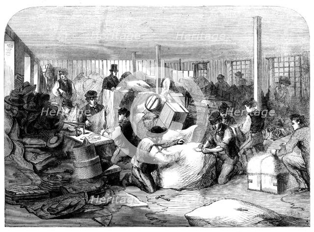 The Cotton Famine: making up parcels of clothing at the industrial institution, Manchester, 1862. Creator: Unknown.