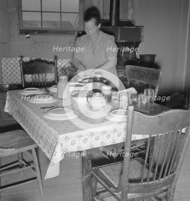 Mrs. Wardlow bakes her own bread in her dugout house, Dead Ox Flat, Oregon, 1939. Creator: Dorothea Lange.