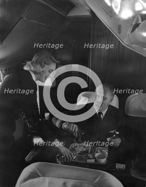 SAS stewardess serving on a flight, 1960. Artist: Torkel Lindeberg