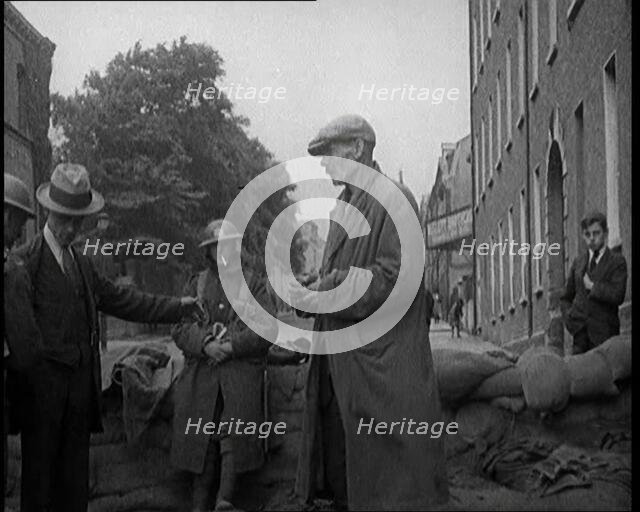 Men Being Stopped and Searched at a Roadblock in Ireland, United Kingdom, 1920. Creator: British Pathe Ltd.