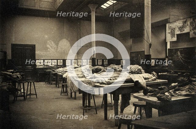 The interior of a dissecting room in Edinburgh, with half-covered cadavers on benches, 1889. Creator: Unknown.
