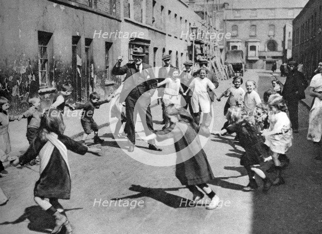 Children dancing in the street, London, 1926-1927. Artist: Unknown