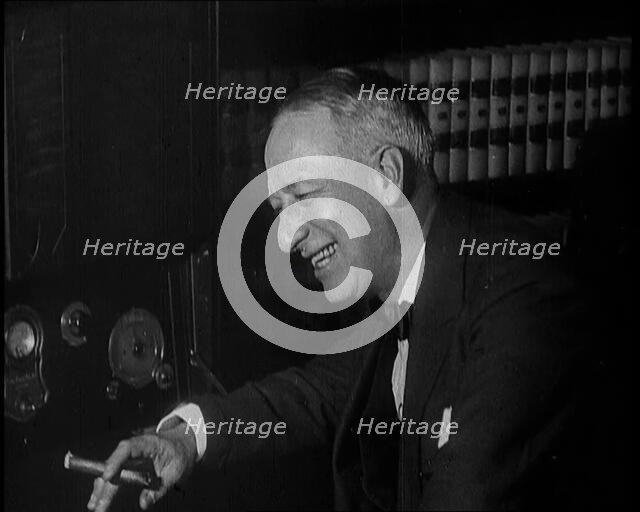 Al Smith, Former Presidential Candidate, Smoking a Cigar And Following Election Results..., 1932. Creator: British Pathe Ltd.