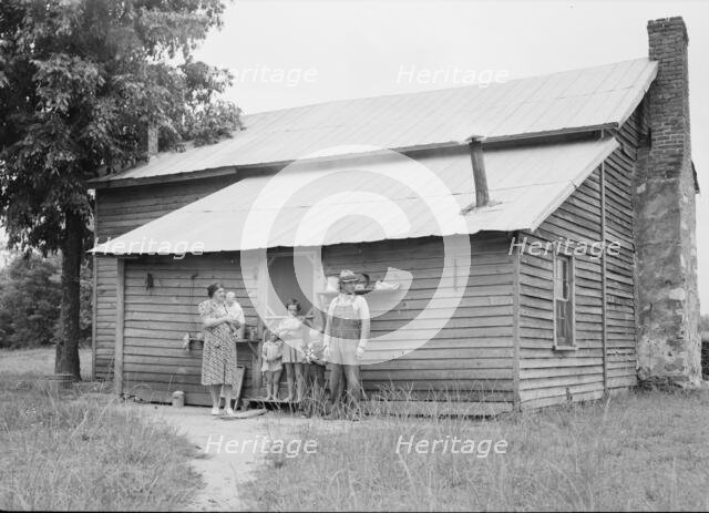 Tobacco sharecropper and his family at the back..., Person County, North Carolina, 1939. Creator: Dorothea Lange.
