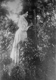 Helen Keller, standing next to tree, 1912. Creator: Bain News Service.