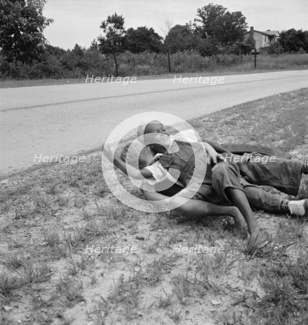 White and Negro boy wrestling by side of road, Person County, North Carolina, 1939. Creator: Dorothea Lange.