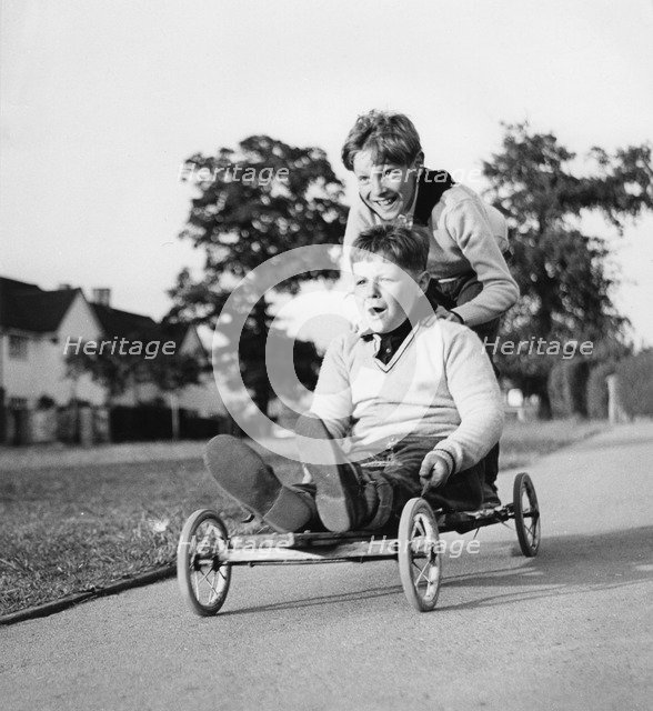 Boys playing with a home-made go-kart, Horley, Surrey, 1965.