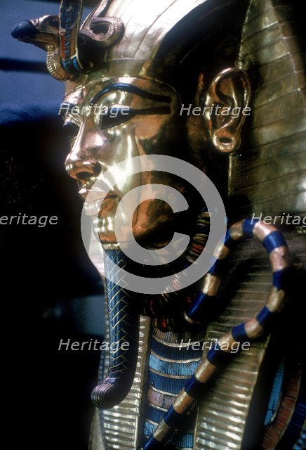 Gold mask of Tutankhamun on the second coffin. Artist: Unknown