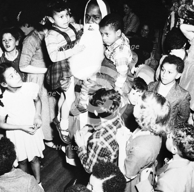A black Father Christmas, London, 1950s. Artist: Henry Grant