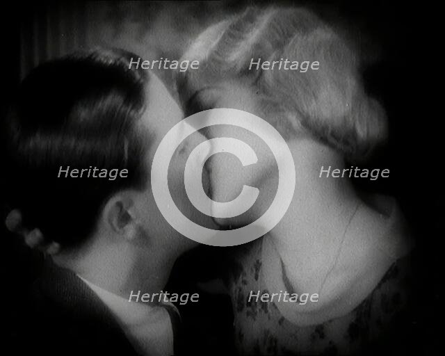 The Actor Ray Milland Kissing a Female British Actor, 1920s. Creator: British Pathe Ltd.