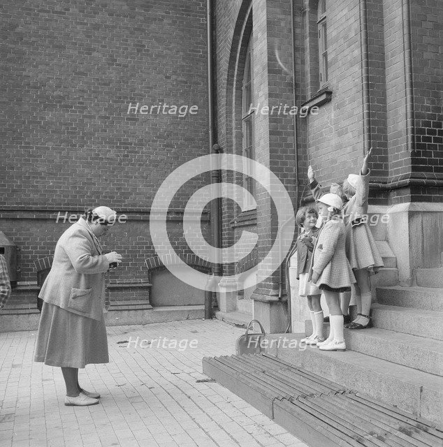 First day at school: a mother photographing her daughter and friends, Landskrona, Sweden, 1952. Artist: Unknown