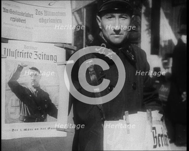 Man Standing by a Poster of Adolf Hitler, 1933. Creator: British Pathe Ltd.