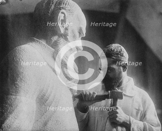 Russian sculptor Sergey Merkurov (1881-1952) working on his statue of Leo Tolstoy Artist: Anonymous  