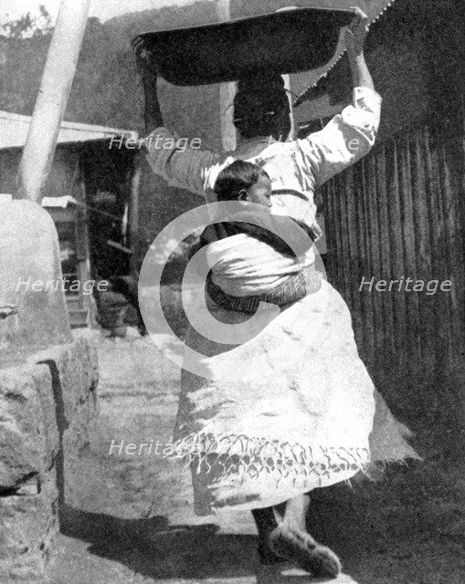 A Korean woman carrying a baby on her back, 1936.Artist: Wide World Photos