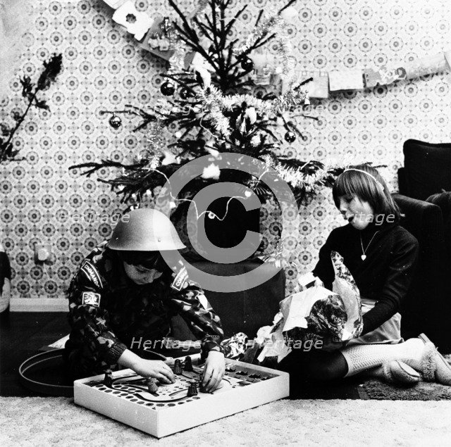Children opening Christmas presents in their London home, c1960s. Artist: Henry Grant