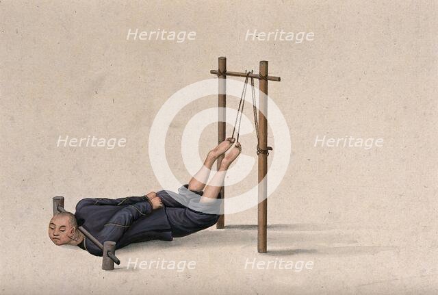 A Chinese man confined to a contraption which ties his legs on to a wooden gallows whilst... Creator: Unknown.