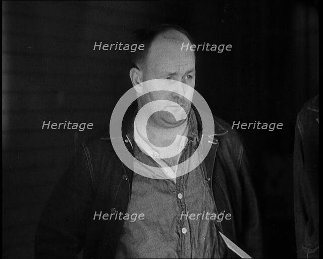 A group of Male Americans Civilians Wearing Prisoners Outfits Being Escorted Into a Room..., 1930. Creator: British Pathe Ltd.