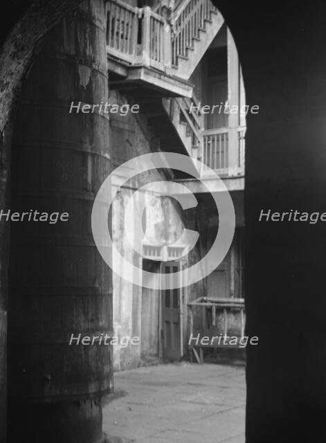 Cistern and outer stairs of an old-time courtyard, New Orleans, between 1920 and 1926. Creator: Arnold Genthe.