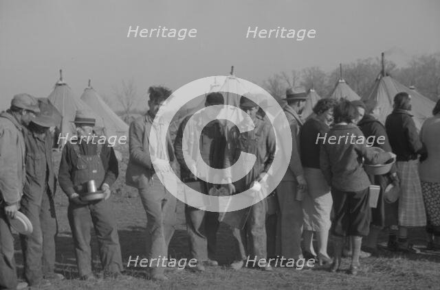 Possibly: Negroes in the lineup for food at the flood refugee camp, Forrest City, Arkansas, 1937. Creator: Walker Evans.