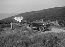 Kitty Brunell road testing a Riley 9 WD tourer, c1930. Artist: Bill Brunell.