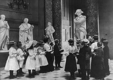 A class of the 6th Division in Statuary Hall, U.S. Capitol, (1899?). Creator: Frances Benjamin Johnston.
