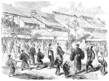 New-Year's Day in Japan - game of battledore and shuttlecock in the streets of Yokohama, 1865. Creator: Unknown.