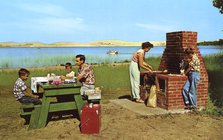 Family having a picnic on the beach by a lake, Michigan, USA, 1955. Artist: Unknown
