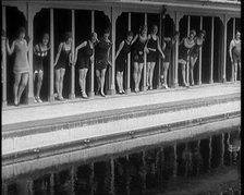 A Group of Young Female Civilians Wearing Short Swimsuits and Heeled Shoes Emerging from..., 1920. Creator: British Pathe Ltd.