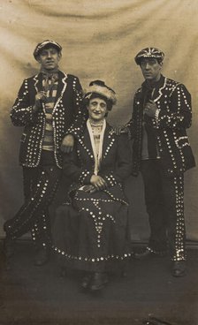 A drag pearly queen and her two kings pose for a group portrait, (between 1910 and 1919?). Creator: Unknown.