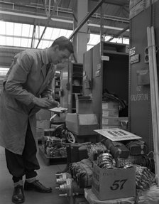 Warehouseman checking stock in the stores at Bestwood Colliery, North Nottinghamshire, 1962. Artist: Michael Walters