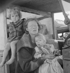 Mother and two children on the road, Tulelake, Siskiyou County, California, 1939. Creator: Dorothea Lange.