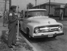 Parking meter with Los Angeles parking control officer 1958. Creator: Unknown.