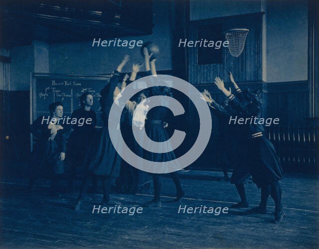 Female students playing basketball in a gymnasium, Western High School, Washington, D.C., (1899?). Creator: Frances Benjamin Johnston.