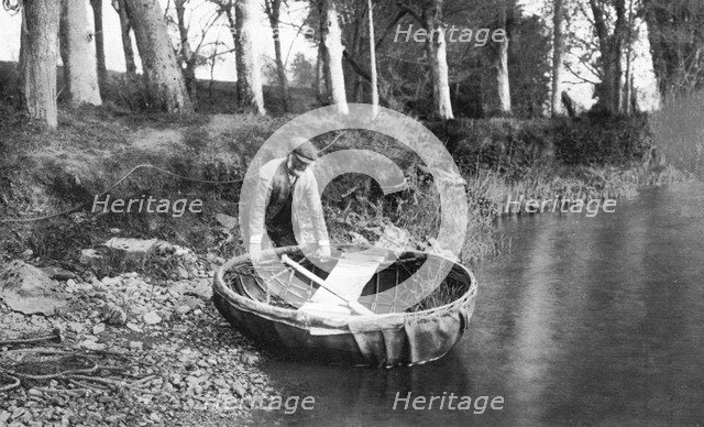 Launching a coracle on the River Boyne, County Meath, Ireland, 1924-1926. Artist: WA Green