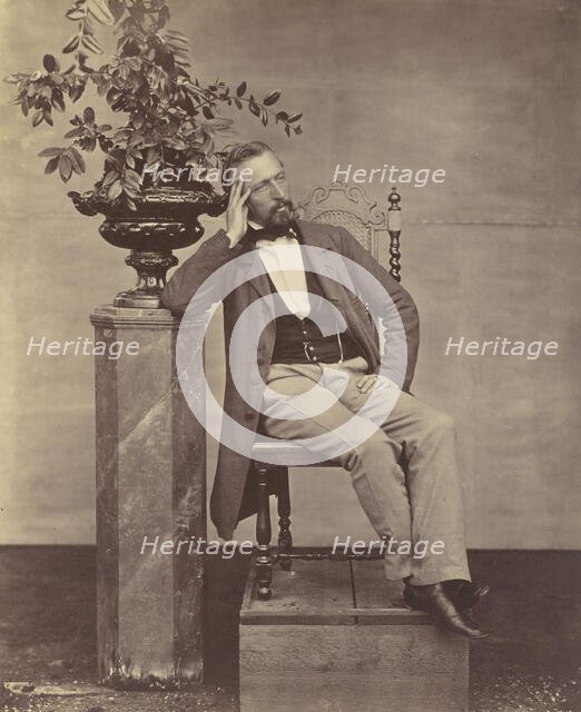 [Mathias Höusermann seated with elbow on pedestal holding a vase of flowers], 1850s-60s. Creator: Franz Antoine.