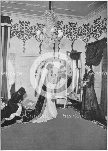 The finishing touches of a dressmaker, London, c1901 (1901). Artist: Unknown.