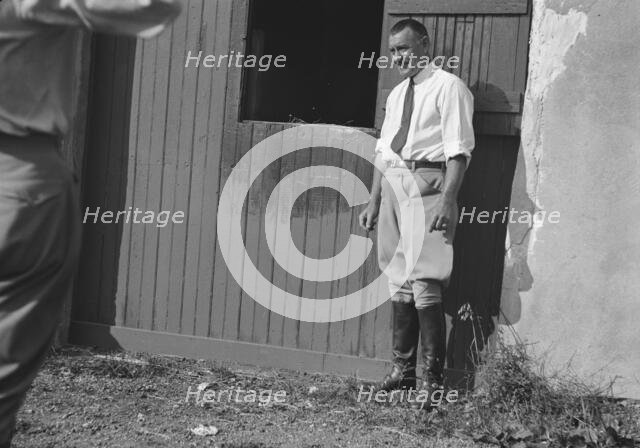 Rothbart, Albert, Mr., grounds, with unidentified man standing by a stable door, c1920-1935. Creator: Arnold Genthe.