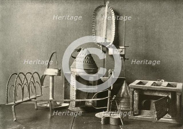 'Foot-warmer; oil lamps; candle sconce; tin lantern; and toaster', c18th century, (1937).  Creator: Unknown.