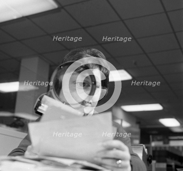 An order gets a close inspection, 1967.  Artist: Michael Walters