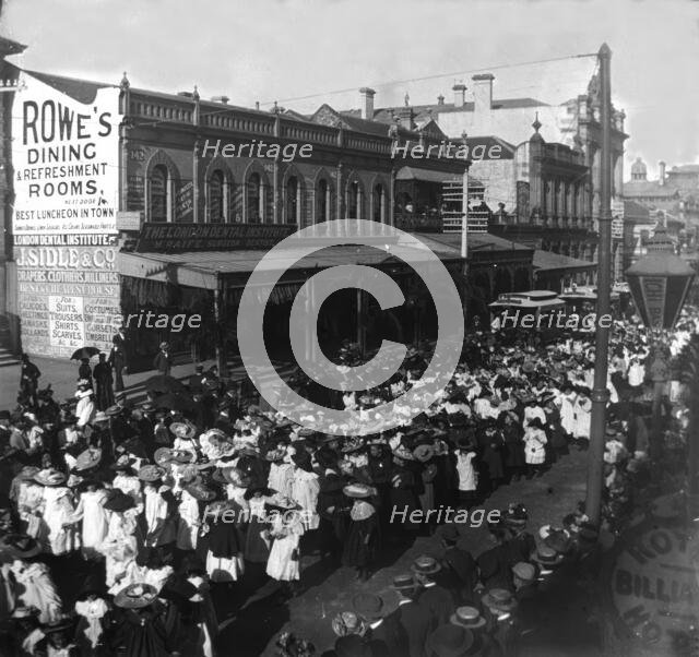 Procession of girls and women out the front of 142, Queen Street corner Edward Street, 1905. Creator: Robert Augustus Henry L'Estrange.