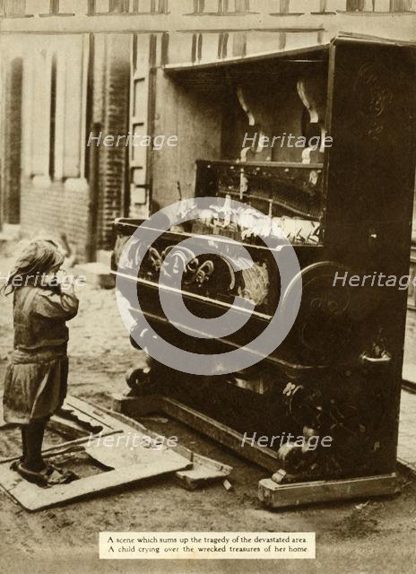 Child with damaged piano after an air raid made her homeless, First World War, 1918, (1935). Creator: Unknown.