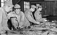 Students loading 50 cal ammunition shells, Flexible Gunnery School, Fort Myers, Florida, USA, 1943. Artist: Southeast Army Air Forces Training Center