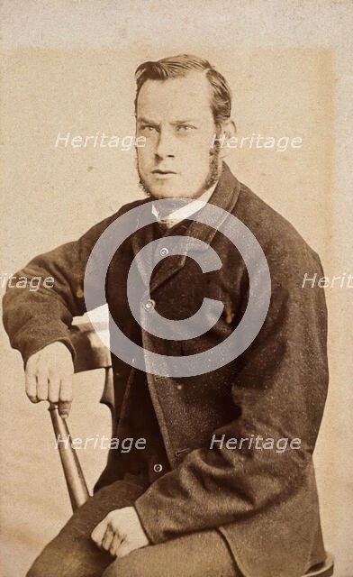 A young man, seated, with an intense expression in his eyes, c1890s. Creator: John Davis.