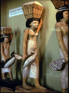 Statue of a peasant woman carrying products of the land to a dead man, made in polychromed wood. …