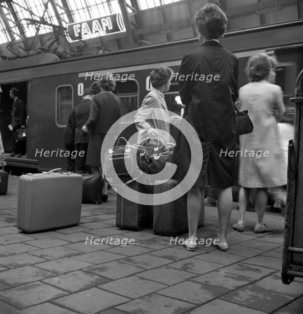 Passengers on a platform at Centraal Station, Amsterdam, Netherlands, 1963. Artist: Michael Walters