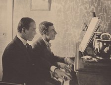 Nijinsky and Maurice Ravel at the piano playing a score from Daphnis and Chloe, 1912. Artist: Anonymous  