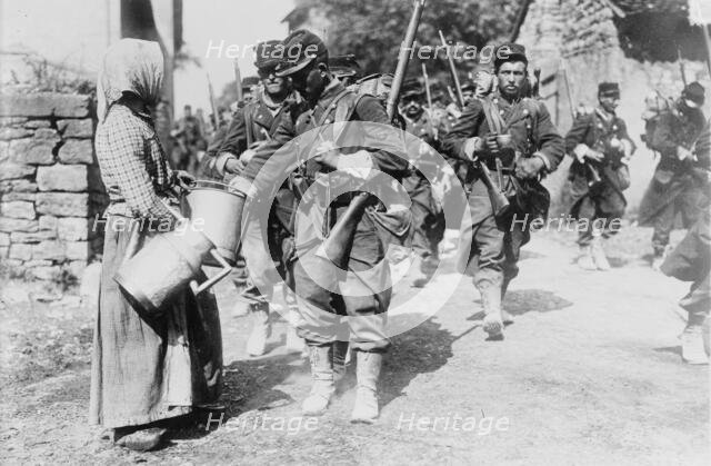 Peasant giving drink to French soldiers, between c1914 and c1915. Creator: Bain News Service.