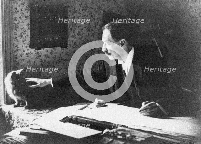 Louis Wain at his drawing board, 1890s. Artist: Anonymous  